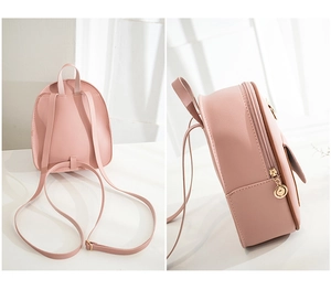 Detailed side view of a pink mini backpack showing synthetic leather and gold zippers