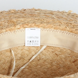 Detail of 100% raffia straw boater hat showing internal weave and sweatband