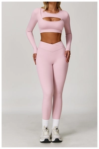 Detail of pink yoga set featuring a cutout long sleeve top and high-waist V-cut leggings