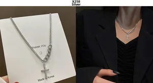 Detailed silver cross pendant necklace featuring asymmetric curb and cuban chain design