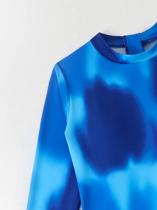 Close-up of the reinforced high collar and blue tie-dye pattern on long sleeve swimwear