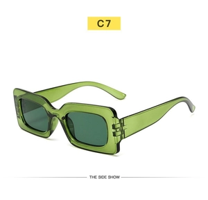 Side view of retro small rectangle sunglasses with translucent green frames and dark lenses