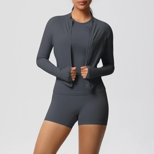 Detail of three-piece charcoal grey yoga set featuring thumbhole jacket and high waist shorts