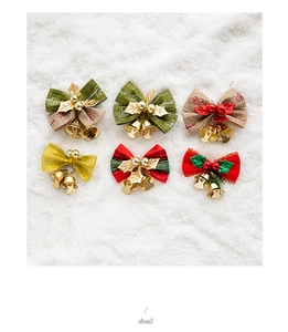 Detail of six festive Christmas bows with jingle bells and berries on a white snow background