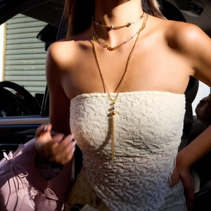 Elegant multi-layer 18K gold and stainless steel necklace with fringe tassels on a model