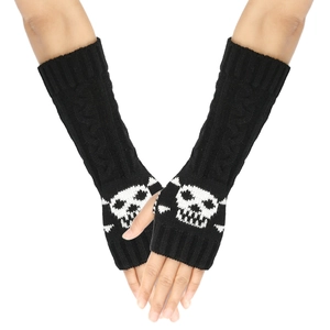 Close-up of black knitted fingerless gloves featuring a white skull pattern on the back