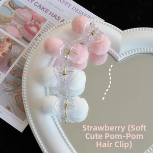 Detail view of heart-shaped fluffy hair claws in pink and white on a mirrored tray