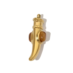 Detail of horn pendant in gold stainless steel featuring a brown tiger eye stone