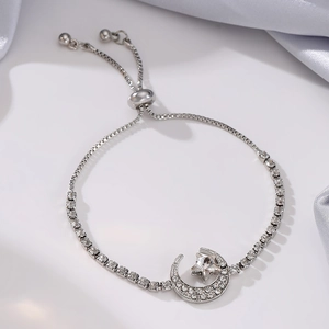 Detail of silver star and moon tassel bracelet with cubic zirconia and box chain