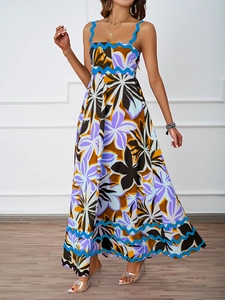 Detail of bohemian summer maxi dress with colorful floral print and blue scalloped trim