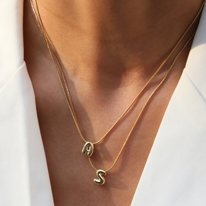 Minimalist double-layer gold snake chain necklace with initial A and S pendants