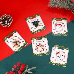 Detail of Christmas brooch set with Santa, tree, and snowman on festive background