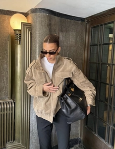 Detail view of khaki faux suede jacket with stand collar and zipper closure