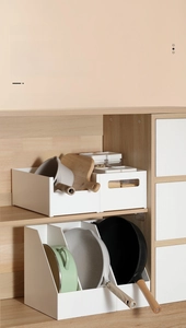 Detailed view of white PP plastic kitchen organizers storing pans and pots in a wooden cabinet