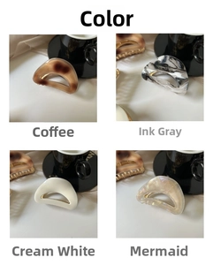 Detail of acetate hair claws in coffee, ink grey, cream, and mermaid iridescent colors