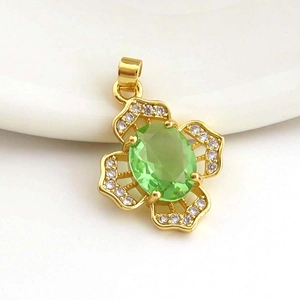 Detail of flower-shaped gold pendant with a light green gemstone and zircon accents