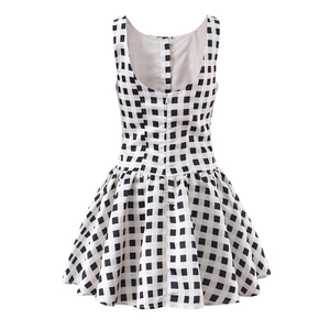 Detail view of plaid sleeveless dress featuring back invisible zipper and pleated hemline