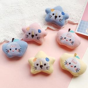 Close-up of plush cartoon stars and apples embroidery patches for DIY clothing decoration