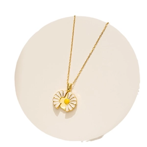 Golden stainless steel necklace with white enamel daisy flower pendant on white background