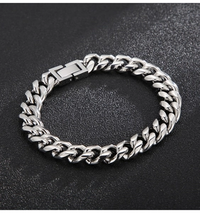 Detailed close-up of a silver 10mm Cuban link bracelet with rectangular clasp on black surface