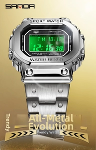 Macro detail of the silver brushed metal case and green backlit LCD of the digital watch