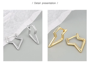 Detail presentation showing silver and golden lightning bolt earrings in polished finish