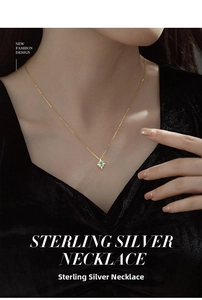 Close-up of S925 silver gold necklace featuring a blue star pendant on a female model