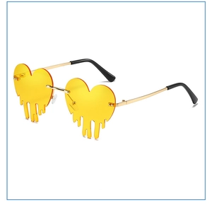 Close-up of heart-shaped yellow sunglasses with lava drip effect and gold metal frame