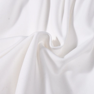 Detailed macro view of white elastic fabric with soft texture and spiral pleated design