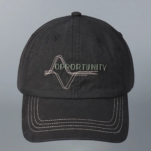 Close-up detail of a black washed cotton baseball cap with 'OPPORTUNITY' embroidery