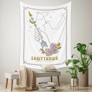 Detail of white Sagittarius tapestry featuring hand with arrow, pink roses and star charts
