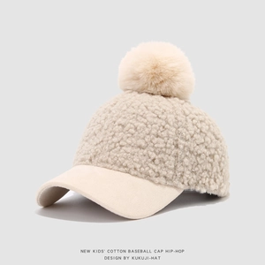 Detail of sherpa lamb wool kids baseball cap with faux fur pom and suede brim