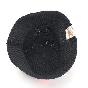Chunky black knit bucket hat for women with embroidered white label for winter style