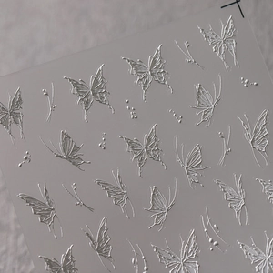 3D embossed silver butterfly nail art stickers with metallic texture for professional manicures