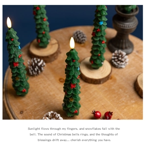 Detail of green Christmas tree LED candle on wood slices with pine cones and poem