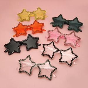 Detail view of colorful star-shaped rimless sunglasses with sparkling rhinestone crystals
