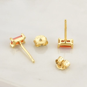 Macro view of S925 silver stud earrings with orange zircon stones and S925 hallmark