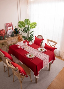 Close-up of red Christmas tablecloth with reindeer jacquard and white tassel fringes