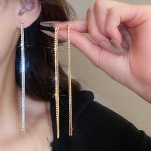 Detail of silver needle tassel earrings with gold and silver sparkling rhinestones