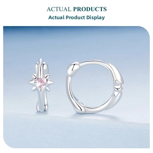 Detailed close-up of S925 silver star earrings with a heart-shaped pink gemstone