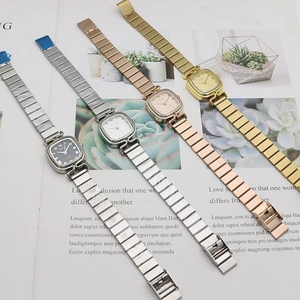 Close-up of square vintage quartz watches with flexible bamboo-style metal expansion bands