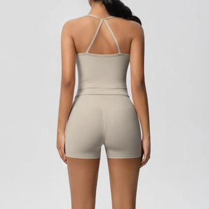 Detailed back view of a beige yoga set with cross-strap sports top and high-waist shorts