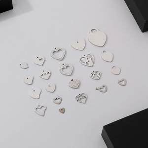 Collection of silver stainless steel heart pendants in hollow, solid, and rhinestone designs