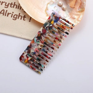 Detail of colorful terrazzo pattern acetate hair comb with wide teeth and smooth finish