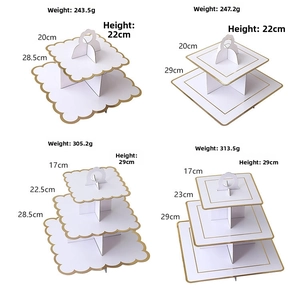 Detail view of multi-tier white cardboard dessert stands with gold foil scalloped edges