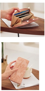 Detail of pink floral embossed leather wallet with multiple card slots and phone storage