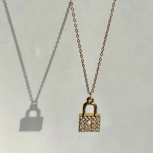 Detail of 18k gold plated padlock pendant necklace with shimmering zircon pavé crystals