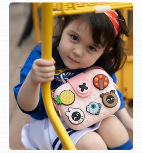 Girl wearing pink silicone crossbody bag with cartoon charms and soft texture