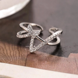 Silver butterfly open ring with sparkling cubic zirconia on blurred background