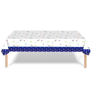 Detail of dinosaur theme party tablecloth with colorful stars and dinosaur footprints